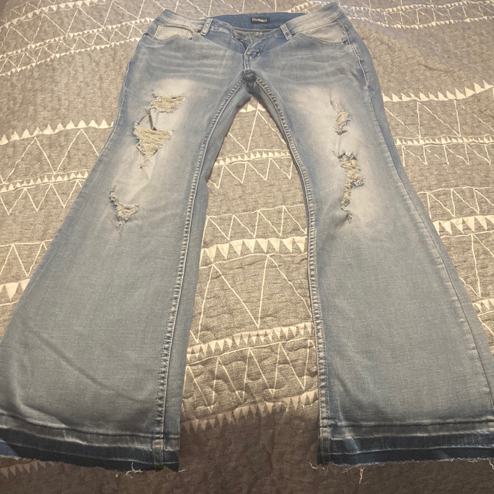 Ripped and frayed jeans,wide legged with fray on bottoms